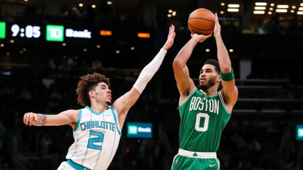 Jan 19, 2022; Boston, Massachusetts, USA; Boston Celtics forward Jayson Tatum (0) shoots defended by Charlotte Hornets guard LaMelo Ball (2) during the second half at TD Garden. Mandatory Credit: Paul Rutherford-USA TODAY Sports